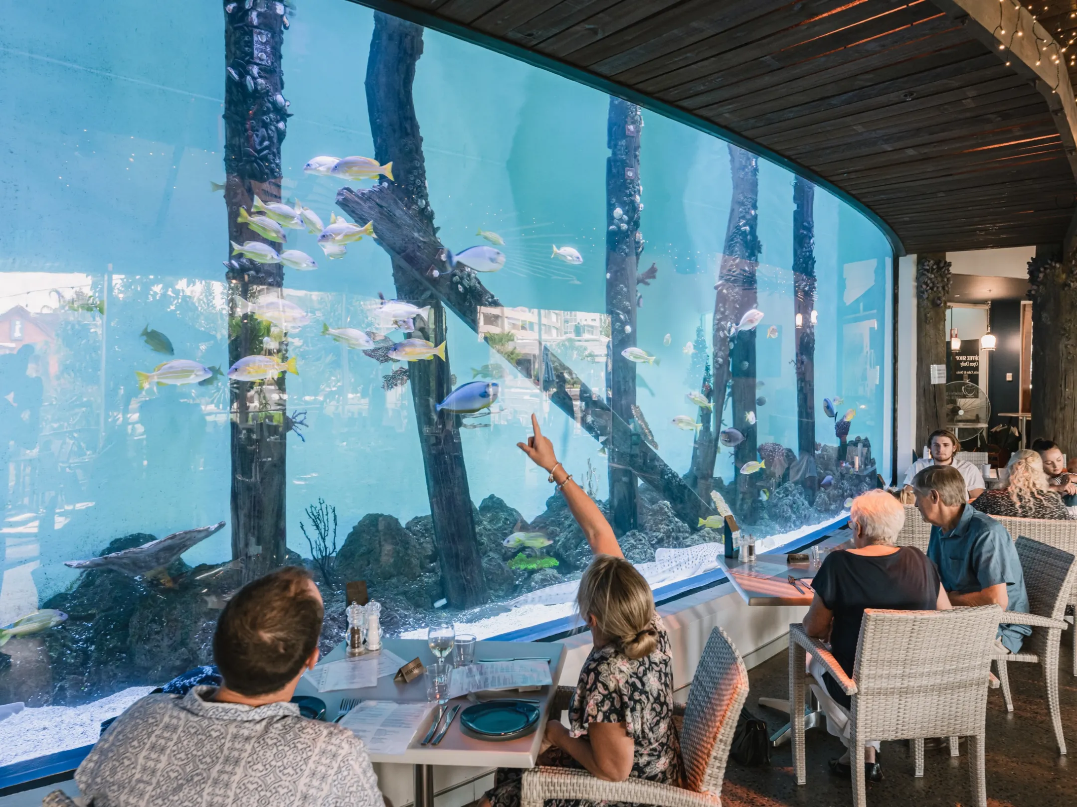a group of people sitting at a table in front of a building