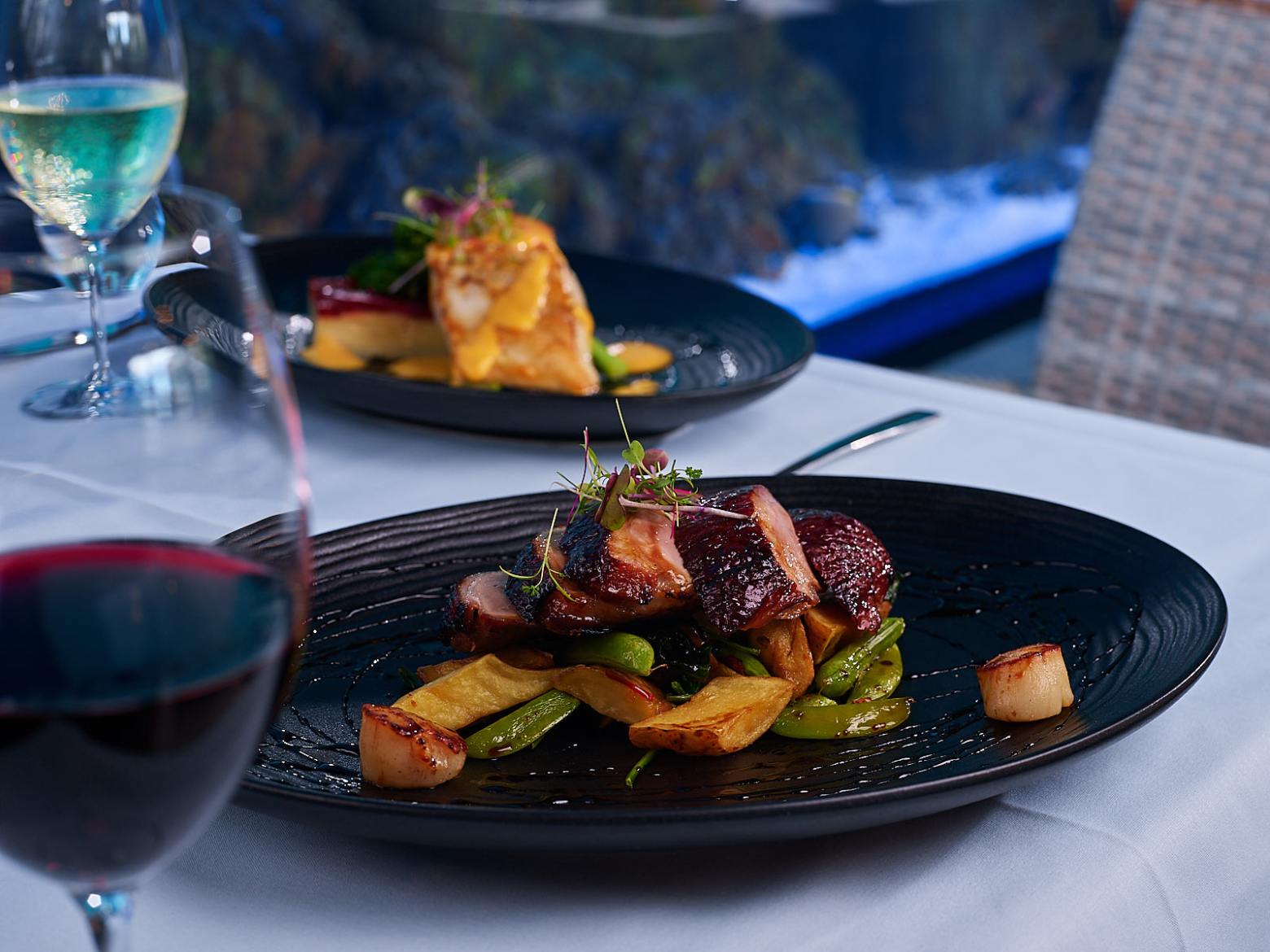 a plate of food and a glass of wine